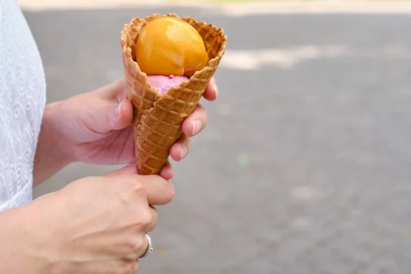 Delicious traditional italian ice cream in woman hands. Natural homemade gelato closeup. Summer sweet tasty dessert. Refreshes in hot weather. Healthy eating, organic food. Take away product