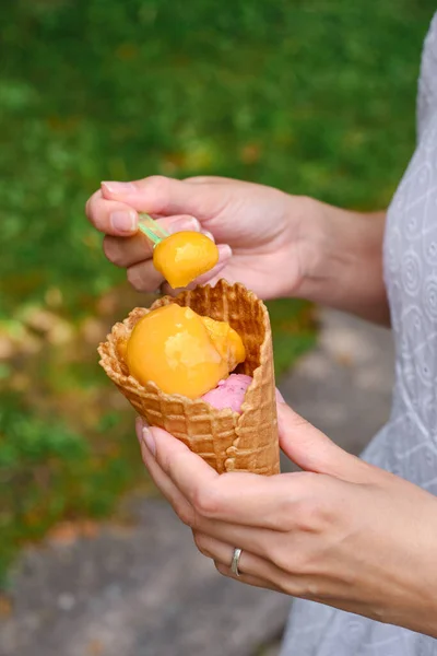 Delicious traditional italian ice cream in woman hands. Natural homemade gelato closeup. Summer sweet tasty dessert. Refreshes in hot weather. Healthy eating, organic food. Take away product