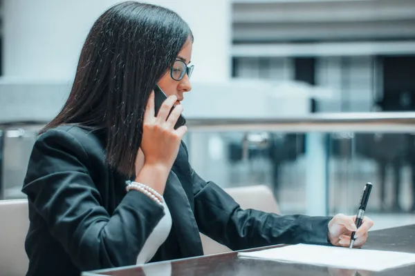 Managerin ruft eine Kundin an, um mit ihrem Handy im Büro zu kommunizieren — Stockfoto