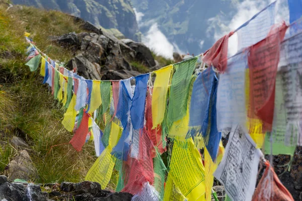 A Tibetan prayer flag in mountains: Lung ta, prayer flag, mantra, Buddhism, Annapurna, Himalayas, Tibet, Nepal
