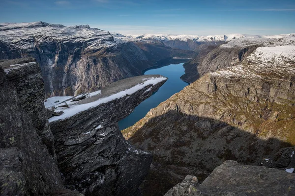 Winter landscape of beautiful Norwegian mountains: Trolltunga, Troltunga, Troll's tongue, Troll tongue, Skjeggedal rock, lake Ringedalsvatnet, Norway