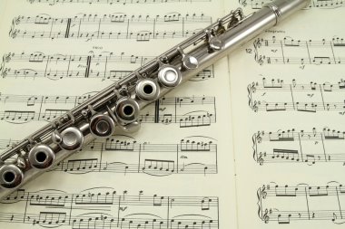 Flute on a Music Book clipart