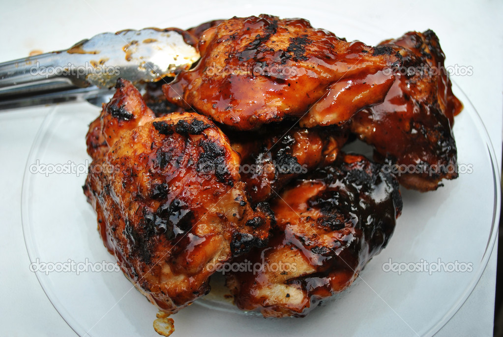 Tongs Holding Barbequed Chicken