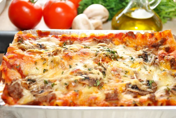 Fresh Ingredients Behind a Pan of Lasagna — Stock Photo, Image