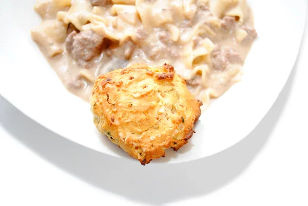 A Biscuit as a Side Dish of a Gravy Pasta Dinner — Stock Photo, Image