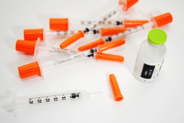 A Vial of Insuline with Disposable Needles clipart