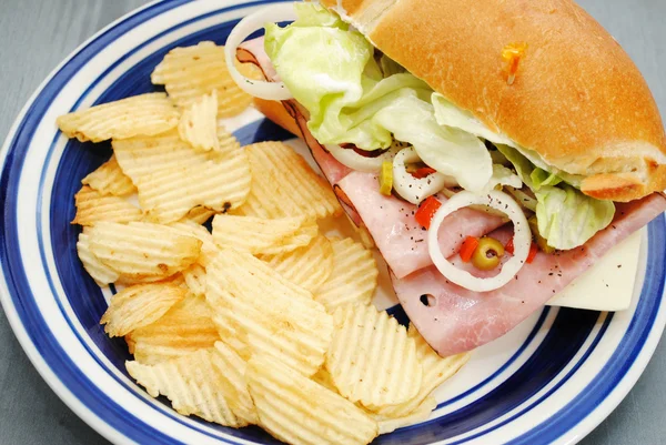 A Delicious Sub Sandwich with a Side of Potato Chips — Stock Photo, Image
