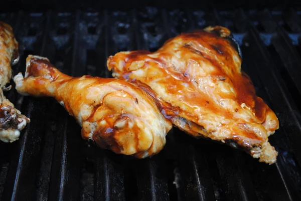Barbequing a Saucy Chicken Leg and Thigh — Stock Photo, Image