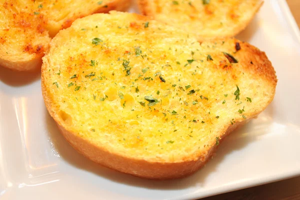 Baked Garlic Bread with Butter and Herbs — Stock Image Baked Garlic Bread with Butter and Herbs Royalty Free Stock Images