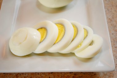 Katı pişmiş yumurta bir tabağa dilimlenmiş