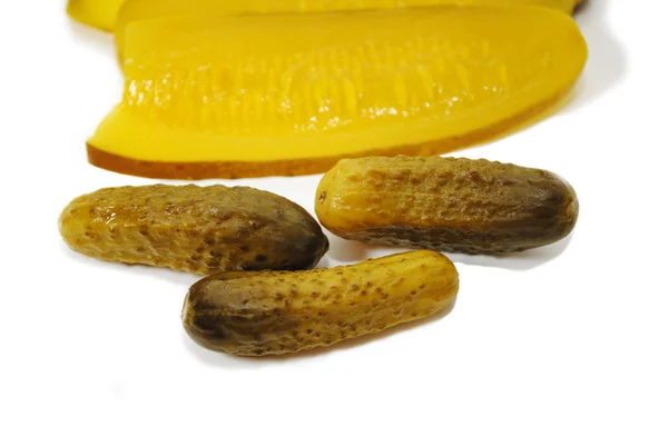 Tiny Whole Pickles in Front of Large Sandwich Sliced Pickles — Stock Photo, Image