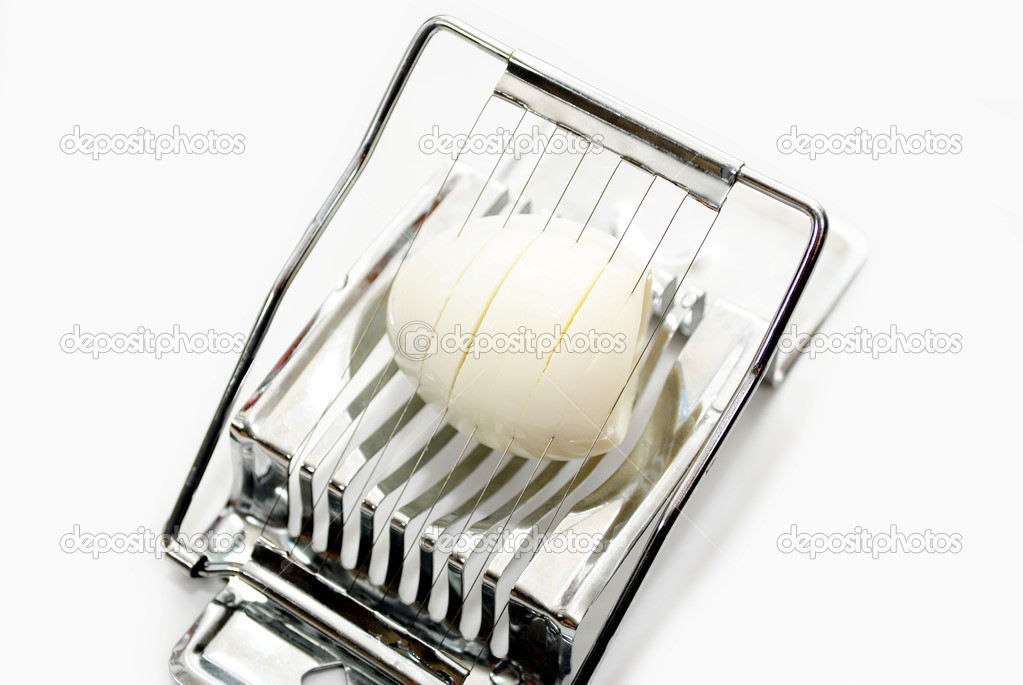 Slicing a Hard Boiled Egg Isolated on White