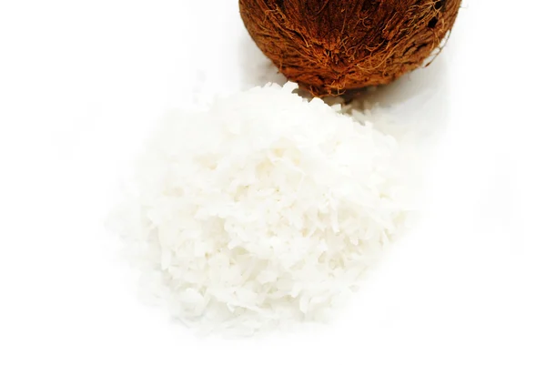 Shredded Coconut with a Whole Coconut in the Background — Stock Photo, Image