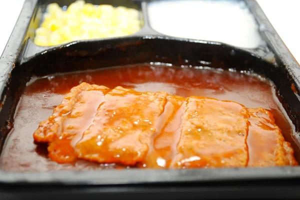 TV Dinner with Focus on a BBQ Boneless Pork Patty — Stok Foto