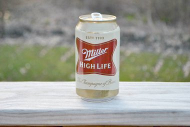 Single Opened Can of Miller High Life Beer Outdoors - This Alcoholic beer is made by the Miller Brewing Company. clipart