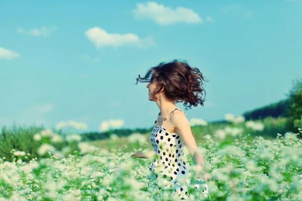 Young happy girl walking on the buckwheat field — Stock Photo, Image
