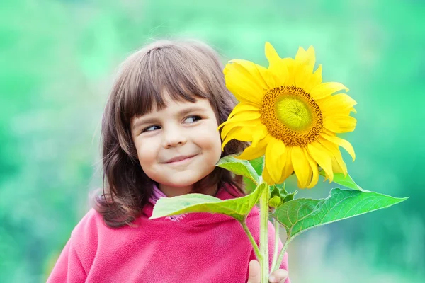 Little girl with sunflower — Stock Photo, Image