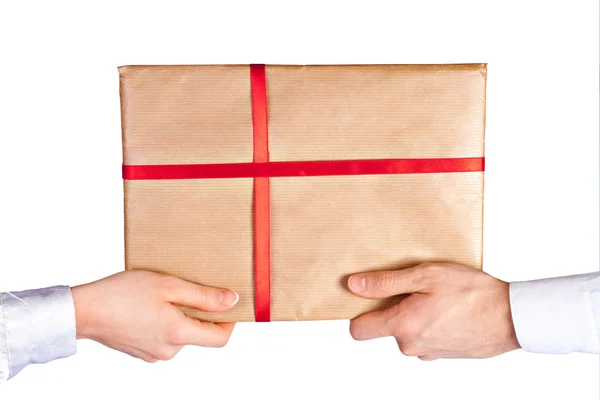 Male and female hands holding a post parcel wrapped — Stock Photo, Image
