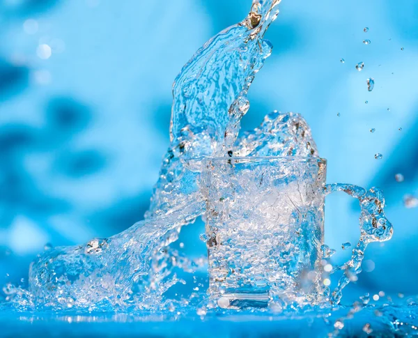 Splashing water from glass — Stock Photo, Image