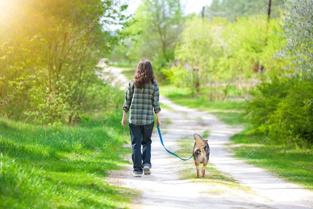 Young woman with her dog walking