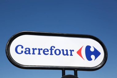 Villars, France - July 16, 2016: Carrefour sign on a panel. Carrefour is a french multinational retailer headquartered in France and it is one of the largest hypermarket chains in the world