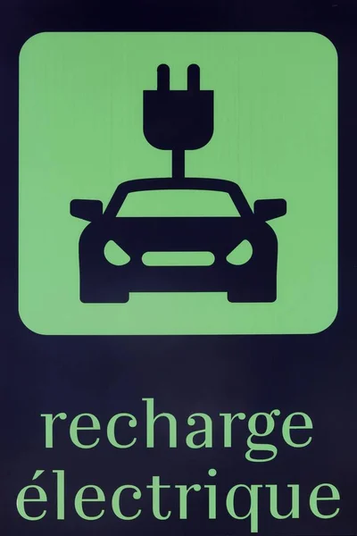 Electric car charging symbol in French language on a parking