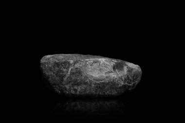 Stone podium on dark black background.	