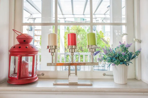 Vase with a flower and candle on the windowsill country house — Stock Photo, Image