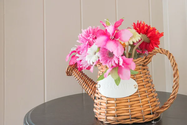 Bouquet of flowers in watering can on wooden table — Stock Photo, Image