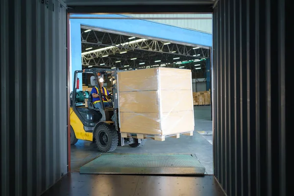 Forklift are loading into cargo containers at warehouses, ports, freight forwarding, cargo supply chains, cargo transportation, warehouse industry, logistics.