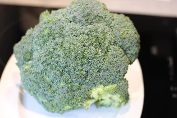 Brokoli Mentah Dalam Piring Putih Pada Latar Belakang Hitam — Stok Foto
