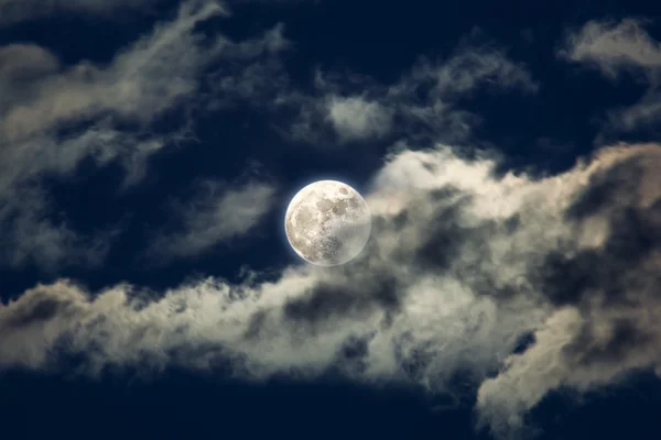 Moon behind the clouds Stock Picture