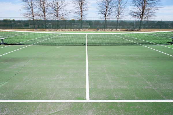 Tennis courts with net and green surface Royalty Free Stock Photos
