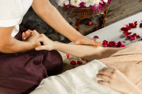 Asian woman enjoying a salt scrub massage at spa. Healthcare spa