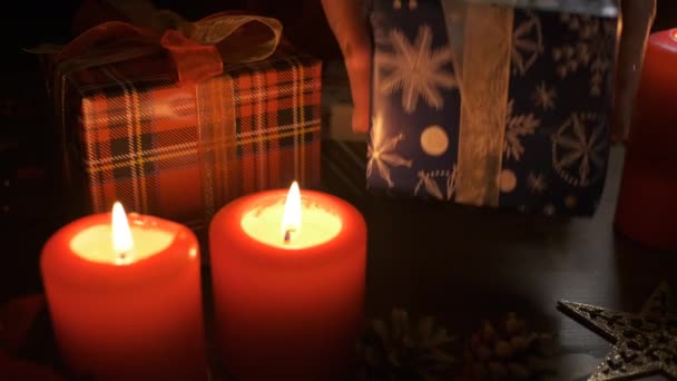 A woman puts a gift on a table decorated with Christmas decorations. — Stock Video