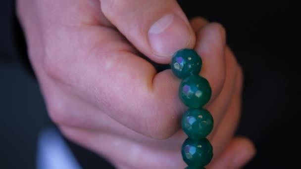 Prayer beads in mens hand on dark. Religious tradition. Close up — Stock Video