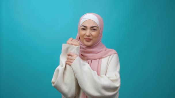 Повреждена рука. Расстроенная молодая мусульманка в хиджабе массирует больное запястье, страдает воспалением суставов от ревматоидного артрита, жестких мышц, синдрома запястного канала. закрытая студия — стоковое видео