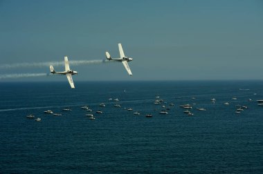 Gijon, Spain - July 24, 2022. Aerosparx, twin planes from British aerobatic team flying over sea at Gijon International Air festival 2022.