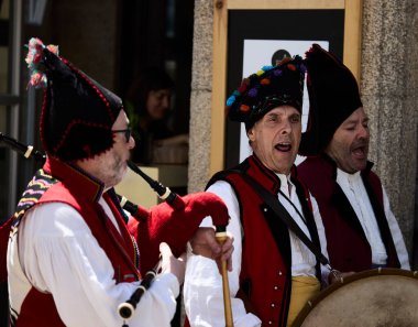 Santiago de Compostela, July 30, 2022. Pipers. Musicians playing a typical Galician instrument, the bagpipe. They are dressed in traditional clothing.