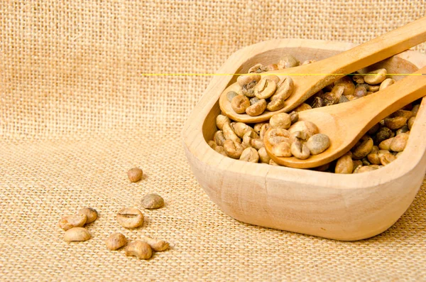 stock image Coffee beans on wooden spoons and cup