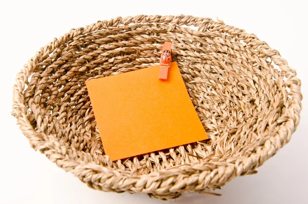 Pinned orange notepad in weave basket — Stock Photo, Image
