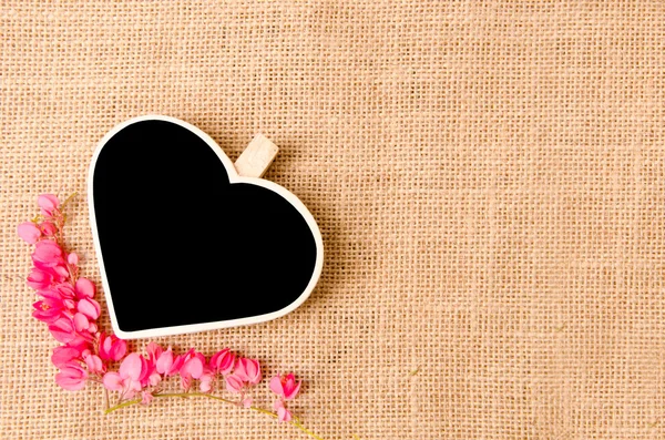 Black wood clip heart shape and flower — Stock Photo, Image