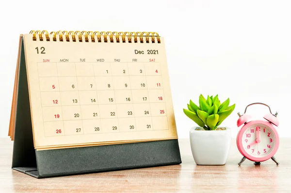 Stock image The December 2021 desk calendar on wooden table.