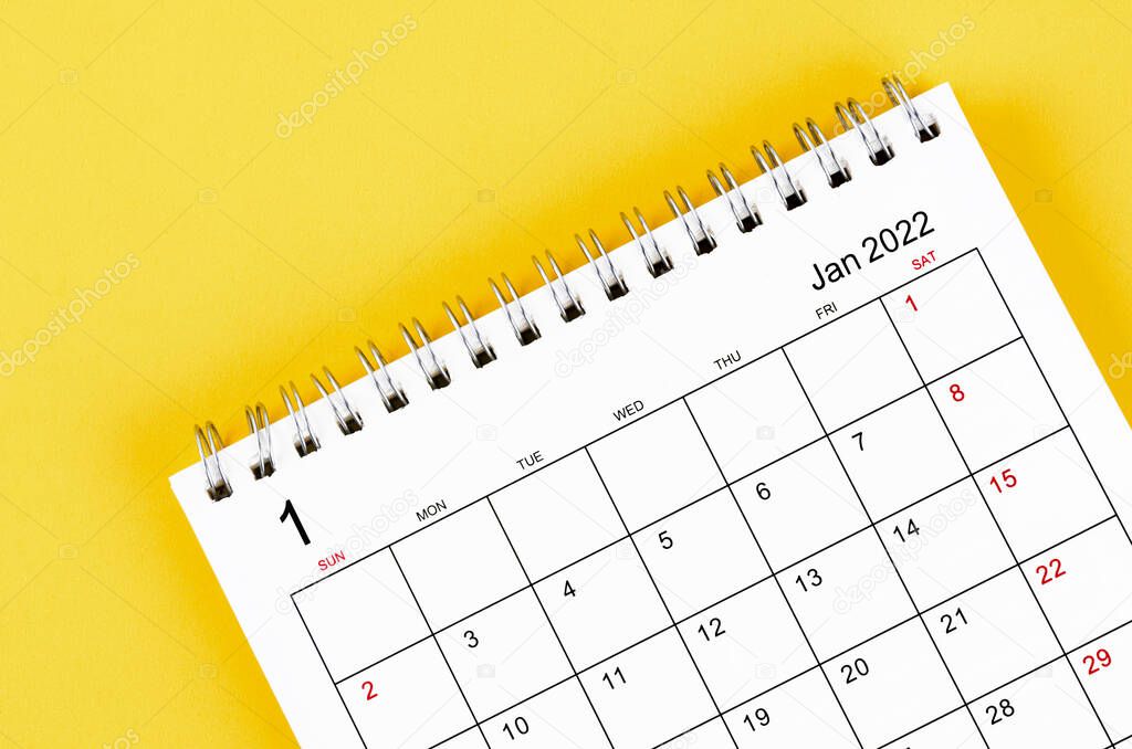 Close-up january 2022 desk calendar on yellow background.