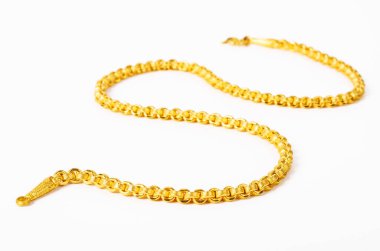 beyaz zemin üzerine altın kolye.