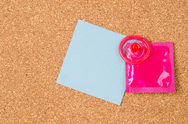 Pink Condom Unpackage Blank Note Paper Wooden Background Copy Space — Stock Photo, Image