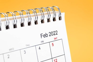 Sarı arkaplandaki Şubat 2022 masa takvimini kapat.
