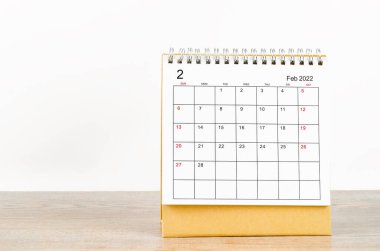 Tahta arka planda Şubat 2022 masa takvimi.