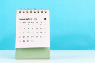 The mini November 2022 desk calendar on blue background.