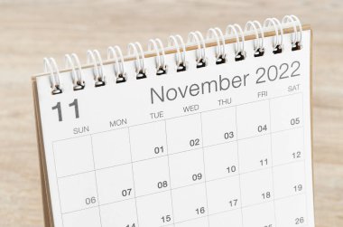 The November 2022 desk calendar on wooden background. clipart